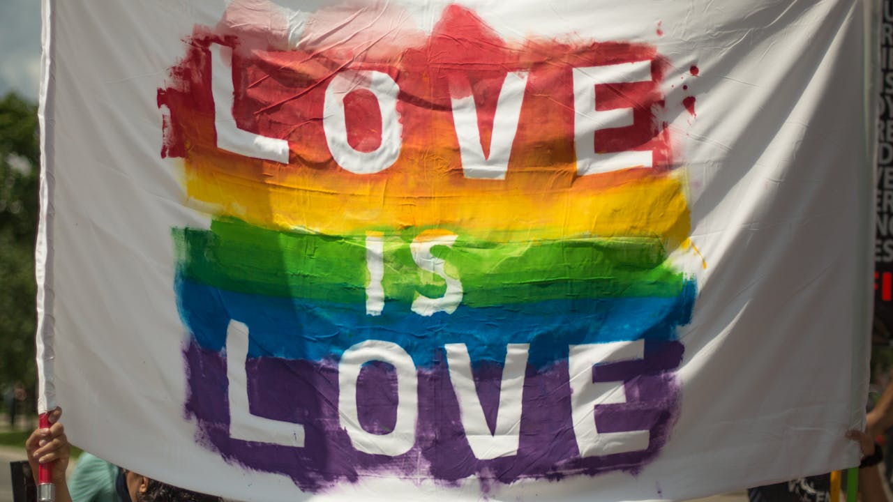 client-satisfaction-img Colorful 'Love is Love' pride banner at a parade in London, Ontario celebrating equality and diversity.
